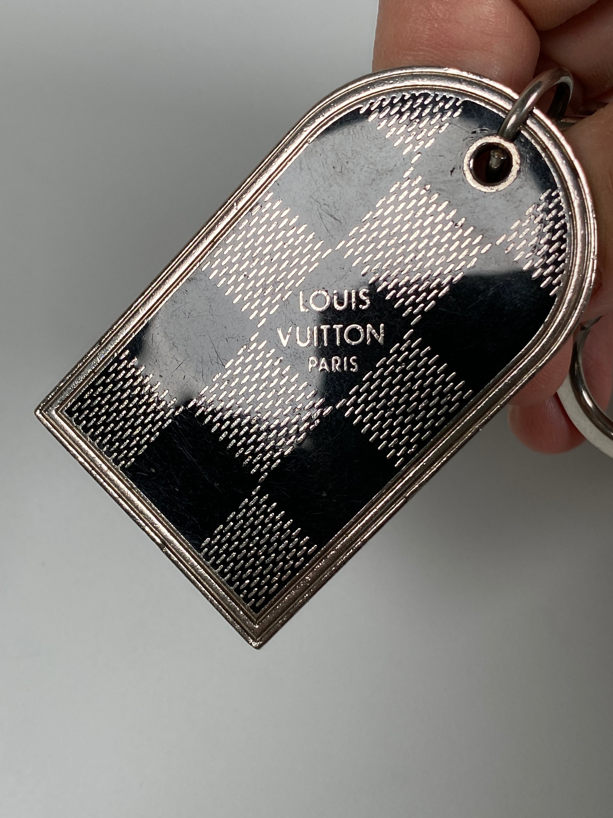 LOUIS VUITTON Gilded metal bag or key ring with a black …